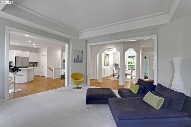 9719 NW Fleischner St, Portland, OR 97229 - living area featuring arched walkways, light colored carpet, recessed lighting, and light wood-type flooring
