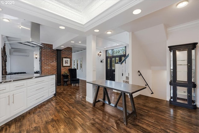 interior space featuring crown molding, a wood stove, recessed lighting, an AC wall unit, and dark wood finished floors