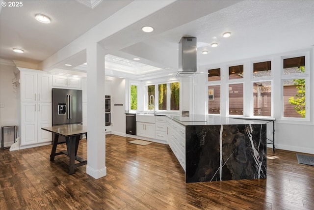 kitchen featuring island exhaust hood, dark wood finished floors, baseboards, black appliances, and ornamental molding