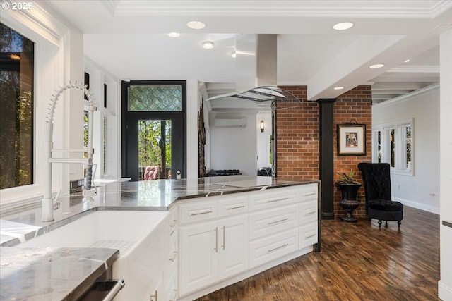 kitchen featuring a wall mounted air conditioner, a sink, dark wood-style floors, ornamental molding, and recessed lighting