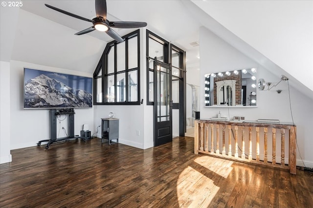 interior space featuring baseboards, ceiling fan, wood finished floors, and lofted ceiling