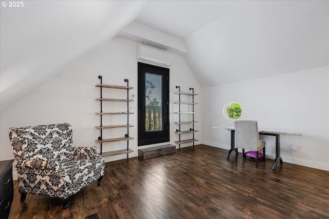 interior space featuring a wall mounted AC, wood finished floors, and lofted ceiling