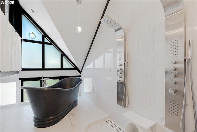 interior space with a freestanding tub, lofted ceiling, and a shower