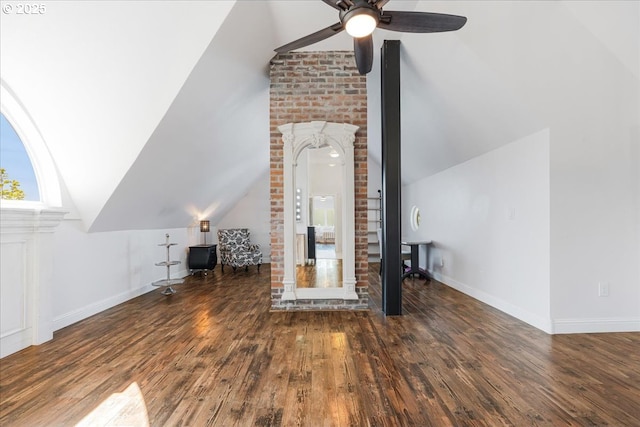 additional living space with baseboards, ceiling fan, wood finished floors, and vaulted ceiling