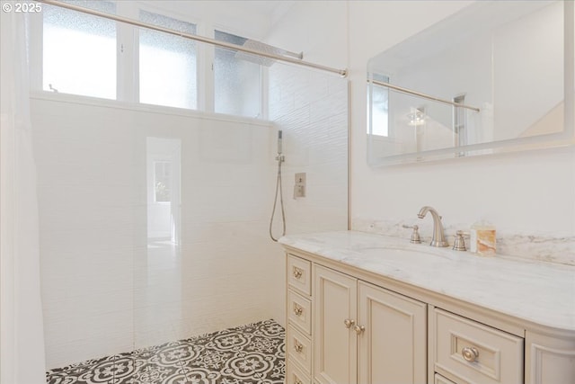 full bath with vanity and tiled shower