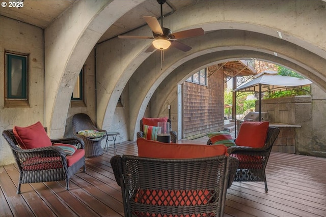 wooden deck with a ceiling fan and an outdoor hangout area