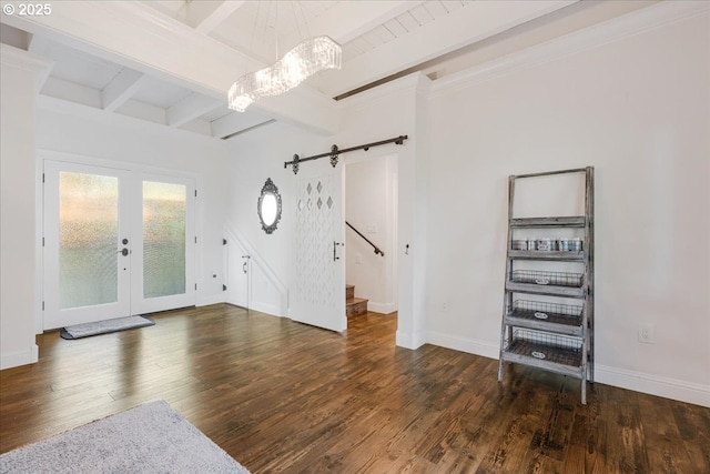 foyer featuring french doors, beam ceiling, wood finished floors, stairway, and baseboards