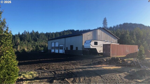 view of outbuilding featuring a wooded view