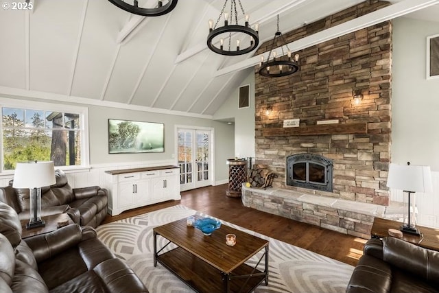 living area with beamed ceiling, dark wood-style flooring, a fireplace, and a wealth of natural light