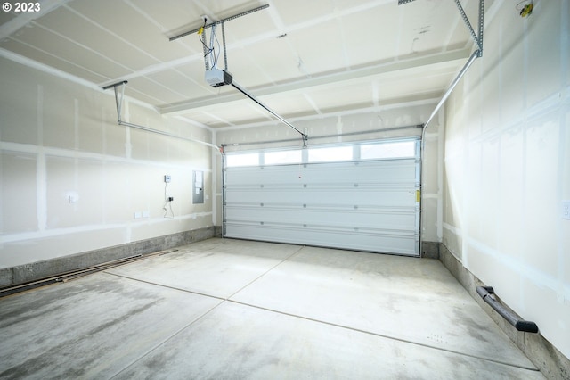 garage with a garage door opener and electric panel