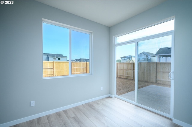 empty room with wood finished floors and baseboards