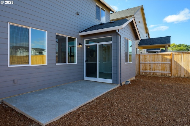 rear view of house featuring a patio area and fence