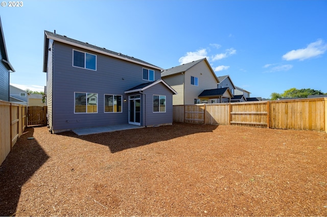 back of house featuring a patio area and a fenced backyard