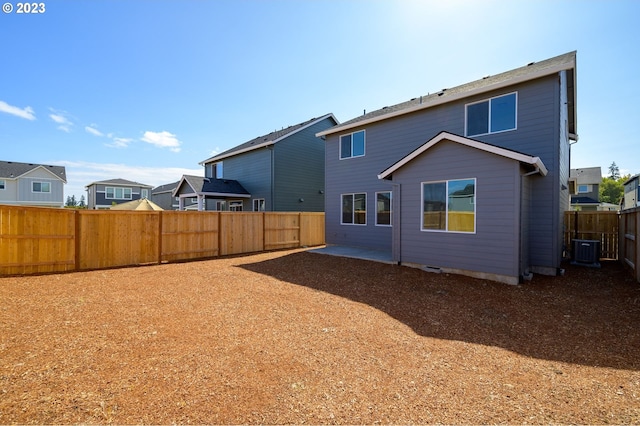 rear view of house featuring a patio area, a fenced backyard, a residential view, and cooling unit