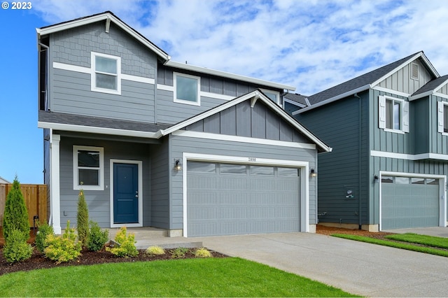 view of front facade featuring board and batten siding, driveway, and fence
