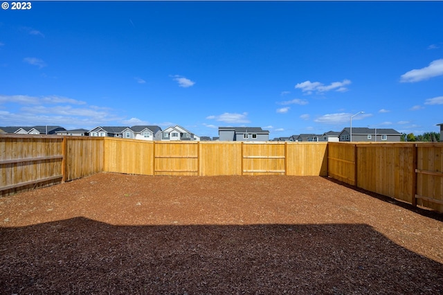 view of yard featuring a residential view and a fenced backyard