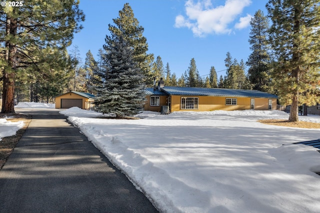 single story home featuring an outbuilding and a garage