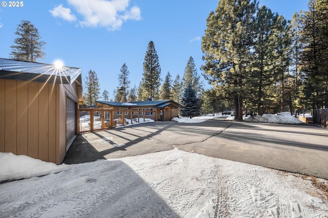 snow covered deck with a garage