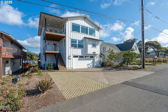 2150 NW Inlet Ave, Lincoln City, OR 97367 - view of front of property with an attached garage, board and batten siding, concrete driveway, and a balcony