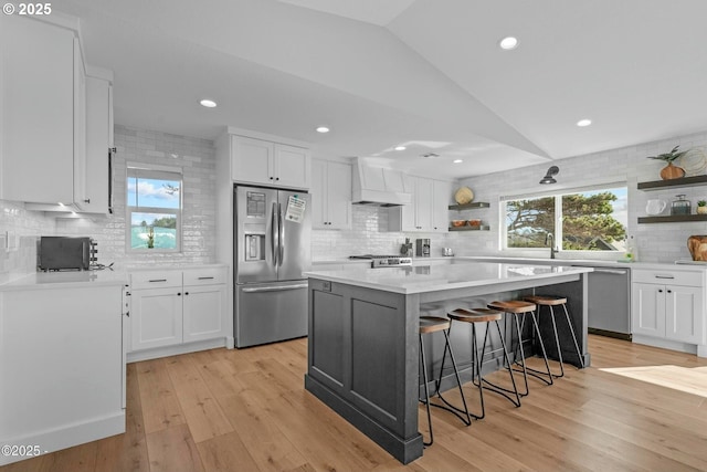 2150 NW Inlet Ave, Lincoln City, OR 97367 - kitchen featuring white cabinetry, decorative backsplash, open shelves, and stainless steel appliances