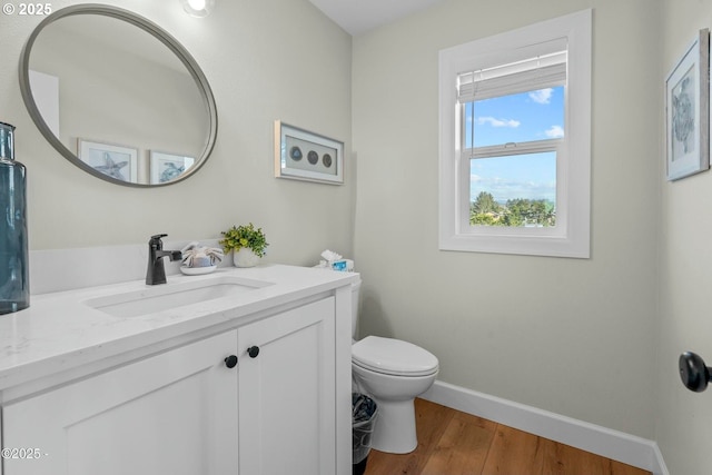 2150 NW Inlet Ave, Lincoln City, OR 97367 - bathroom with vanity, baseboards, toilet, and wood finished floors