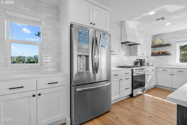 2150 NW Inlet Ave, Lincoln City, OR 97367 - kitchen featuring custom range hood, tasteful backsplash, visible vents, and appliances with stainless steel finishes