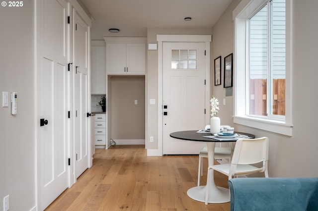 foyer entrance with light hardwood / wood-style flooring