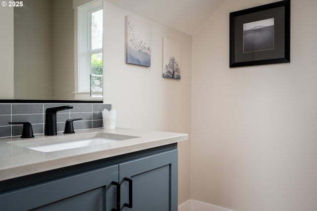 bathroom with vanity and decorative backsplash