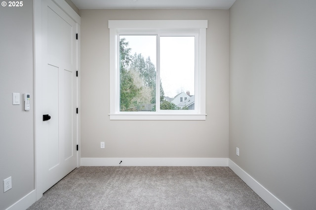 carpeted empty room featuring a wealth of natural light