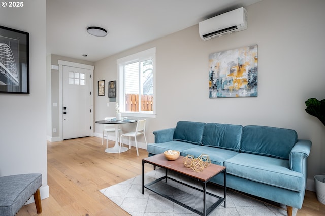 living room with an AC wall unit and light wood-type flooring