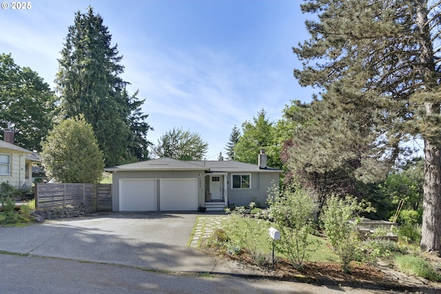 1842 SW Lobelia St, Portland, OR 97219 - view of front facade featuring asphalt driveway, a chimney, and a garage