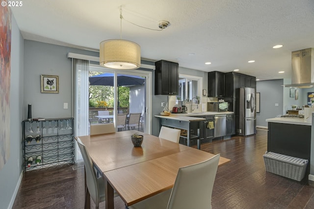 1842 SW Lobelia St, Portland, OR 97219 - dining room featuring dark wood-type flooring, a textured ceiling, and recessed lighting