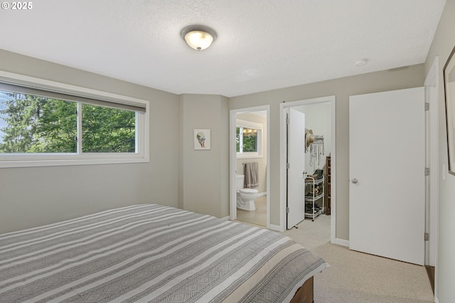 1842 SW Lobelia St, Portland, OR 97219 - bedroom featuring light colored carpet, a textured ceiling, and connected bathroom