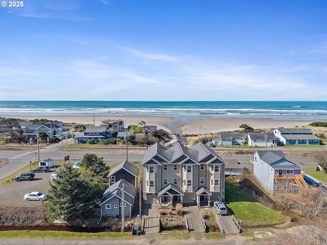 drone / aerial view featuring a view of the beach and a water view