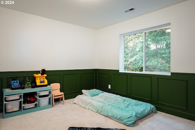 bedroom featuring light colored carpet