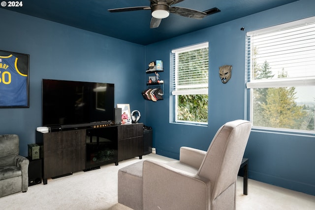 carpeted living room with ceiling fan