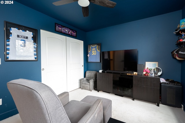 carpeted living room with ceiling fan