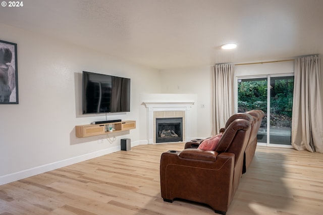 living room with a fireplace and light hardwood / wood-style flooring