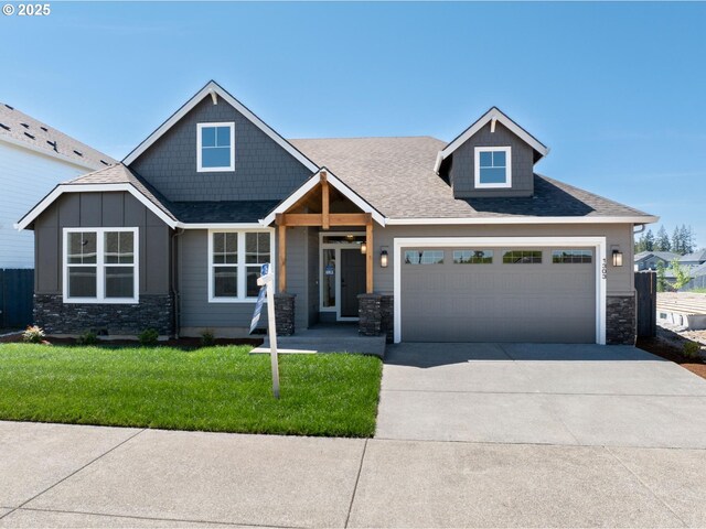 1303 S 46th Pl, Ridgefield, WA 98642 - craftsman inspired home with stone siding, concrete driveway, a front lawn, and an attached garage