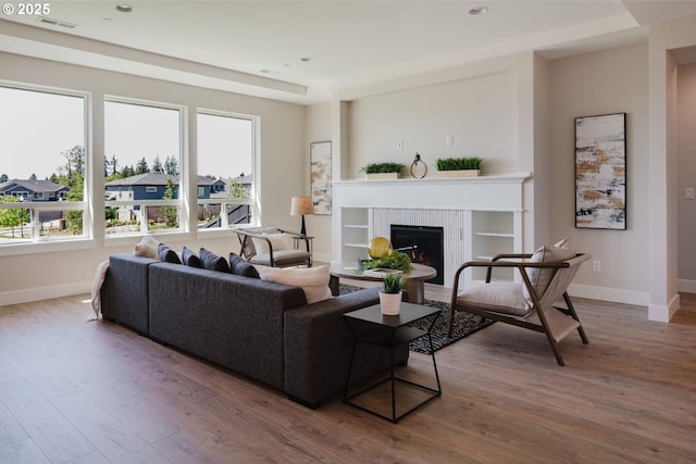 1303 S 46th Pl, Ridgefield, WA 98642 - living room featuring baseboards, hardwood / wood-style flooring, a tile fireplace, and recessed lighting