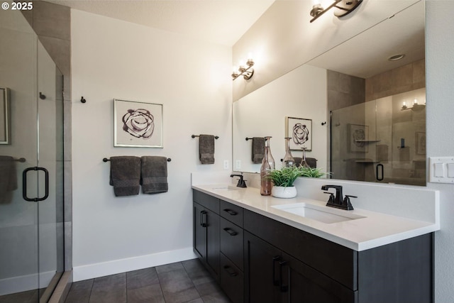 1303 S 46th Pl, Ridgefield, WA 98642 - bathroom featuring a shower stall, double vanity, and baseboards