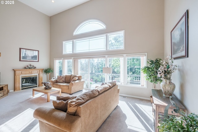 37676 Kathleen Ct, Lebanon, OR 97355 - living area featuring a towering ceiling, light carpet, and a glass covered fireplace