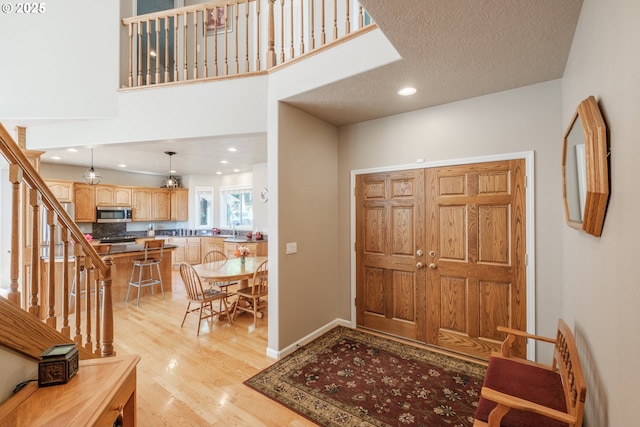 37676 Kathleen Ct, Lebanon, OR 97355 - entryway with light wood-type flooring, stairs, and recessed lighting