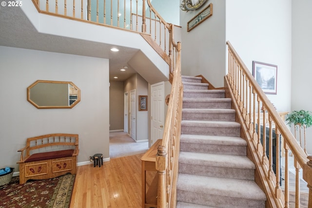 37676 Kathleen Ct, Lebanon, OR 97355 - staircase with wood finished floors, a high ceiling, recessed lighting, and baseboards