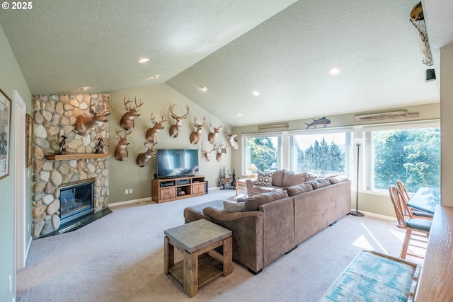 37676 Kathleen Ct, Lebanon, OR 97355 - carpeted living room featuring a textured ceiling, baseboards, a stone fireplace, recessed lighting, and vaulted ceiling