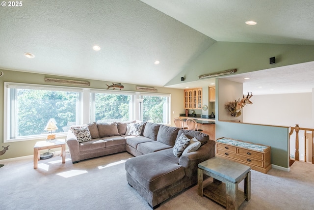 37676 Kathleen Ct, Lebanon, OR 97355 - living area featuring light carpet, a textured ceiling, recessed lighting, vaulted ceiling, and healthy amount of natural light