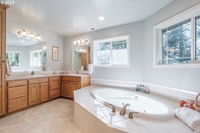 37676 Kathleen Ct, Lebanon, OR 97355 - full bathroom featuring double vanity, plenty of natural light, a whirlpool tub, tile patterned floors, and recessed lighting