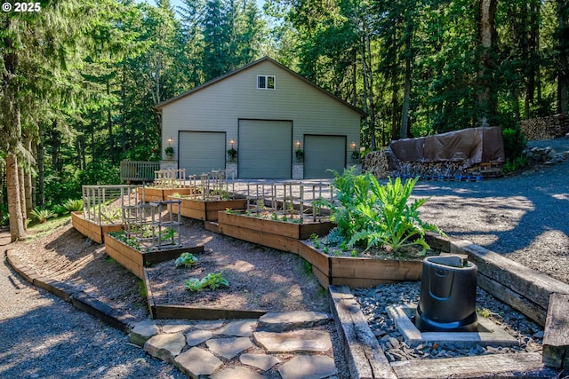 37676 Kathleen Ct, Lebanon, OR 97355 - view of patio featuring a vegetable garden, a garage, and an outbuilding