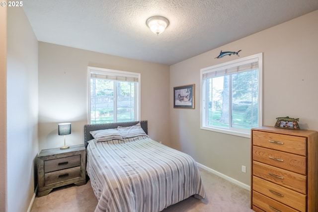 37676 Kathleen Ct, Lebanon, OR 97355 - bedroom with multiple windows, light colored carpet, a textured ceiling, and baseboards