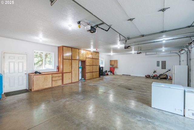 37676 Kathleen Ct, Lebanon, OR 97355 - garage with refrigerator, a garage door opener, and electric panel